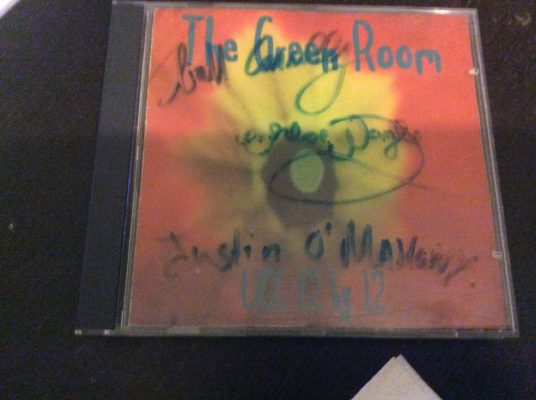 A signed copy of the Green Room UCC Live Music College CD found in Olli's apartment. 